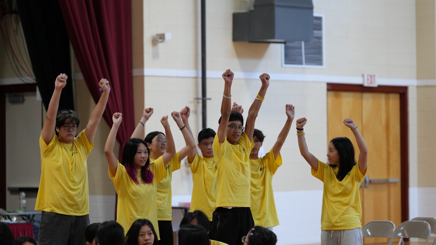 Group celebration fists raised on stage